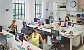 Designers working at desks in open plan office