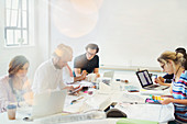 Designers working in conference room meeting