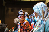 Laughing businesswomen in conference audience