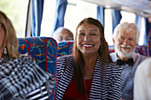 Confident active senior woman tourist riding tour bus