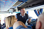 Smiling active senior man tourist on tour bus