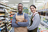 Portrait confident grocers working in supermarket