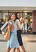 Portrait happy women friends shopping in mall