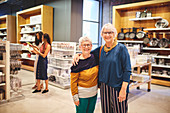 Happy senior women friends shopping in home goods store