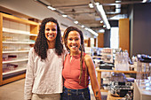 Confident women friends shopping in home goods store