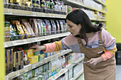 Female grocer with tablet checking inventory in supermarket