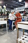 Senior women with tablet and smart phone shopping in store