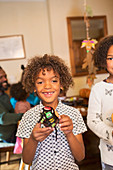 Portrait cute boy with decorated Halloween cupcake