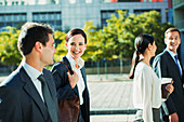 Smiling business people walking outdoors