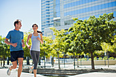 Couple jogging in urban park
