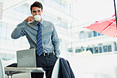 Businessman sipping coffee in office