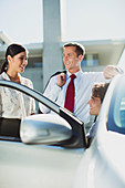 Business people talking at car