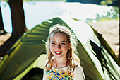 Smiling girl outside tent