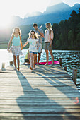 Family walking on dock over lake