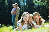 Smiling girls laying in grass