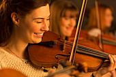 Smiling violinist performing