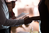 Business people handshaking in conference room