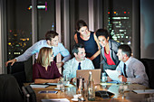 Business people meeting in conference room at night