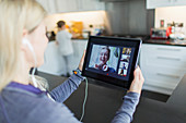 Woman video chatting with friends on digital tablet