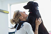 Happy woman hugging dog