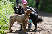 Happy woman with dogs on hiking trail