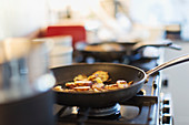 Close up food cooking in skillet on stove