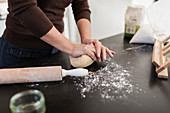 Woman kneading dough on kitchen counter