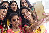 Happy Indian women and girls in saris taking selfie