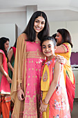 Portrait happy Indian sisters in saris