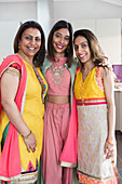 Portrait happy Indian sisters in saris