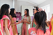 Indian women in saris taking in kitchen