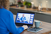 Woman video conferencing with doctor on laptop screen