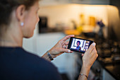 Woman video chatting with friends on smart phone screen