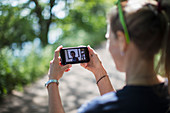 Woman video chatting with friends in sunny park