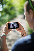 Woman video chatting with friends on smart phone screen