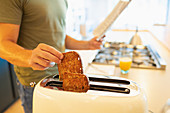 Close up man making toast