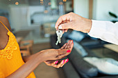 Close up man giving house keys to woman