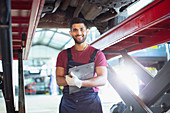 Mechanic working under car