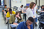 Teacher supervising students taking exam