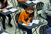 Focused girl student taking exam