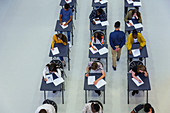 Teacher supervising students taking exam