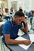 Focused boy student taking exam