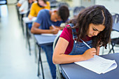 Focused high school girl student taking exam