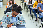 Focused girl student taking exam