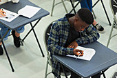 Focused boy student taking exam