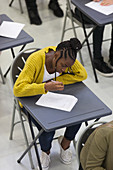 Focused girl student taking exam