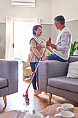 Happy mature couple cleaning