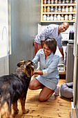 Happy couple with dog in kitchen