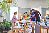 Mature couple friends setting dining table