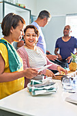 Mature couple friends talking and cooking